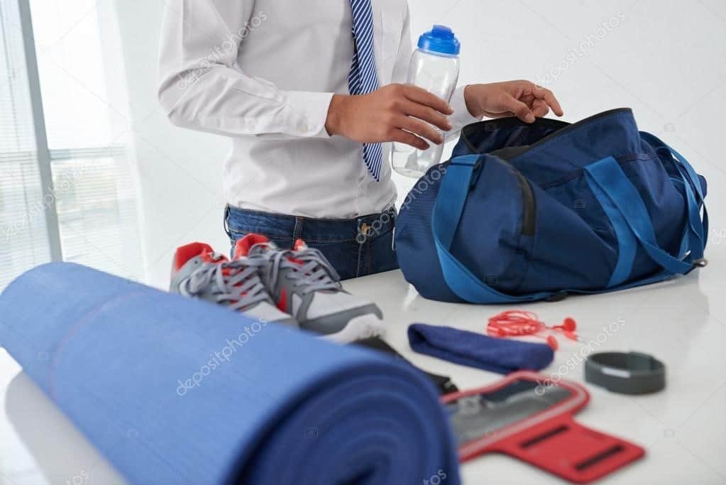 Gym bag contents: wrist wraps, lifting belt, shaker, water bottle and supplements