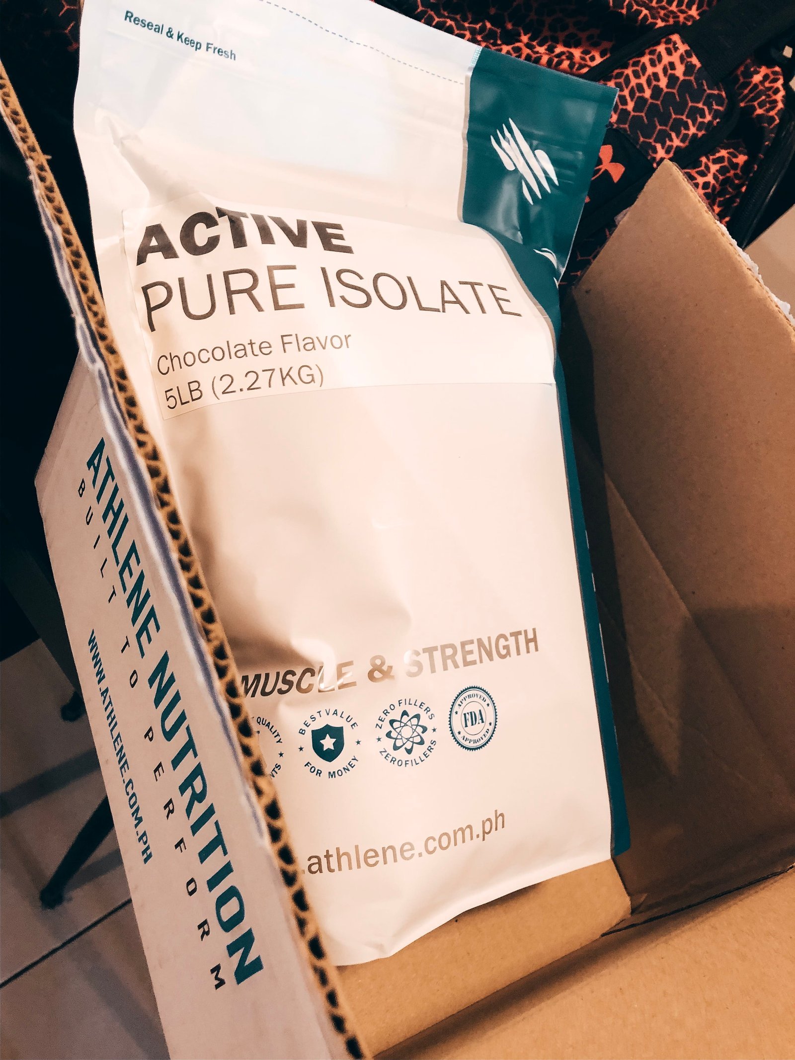 Coach Jeff holding a tub of locally sold whey protein isolate